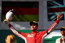 Sebastian Vettel celebrates on the podium with the trophy