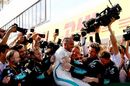 Race winner Lewis Hamilton celebrates with his team in parc ferme