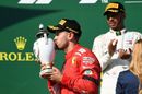 Sebastian Vettel kisses his trophy on the podium