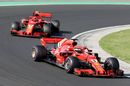 Sebastian Vettel and Kimi Raikkonen on track in the Ferrari