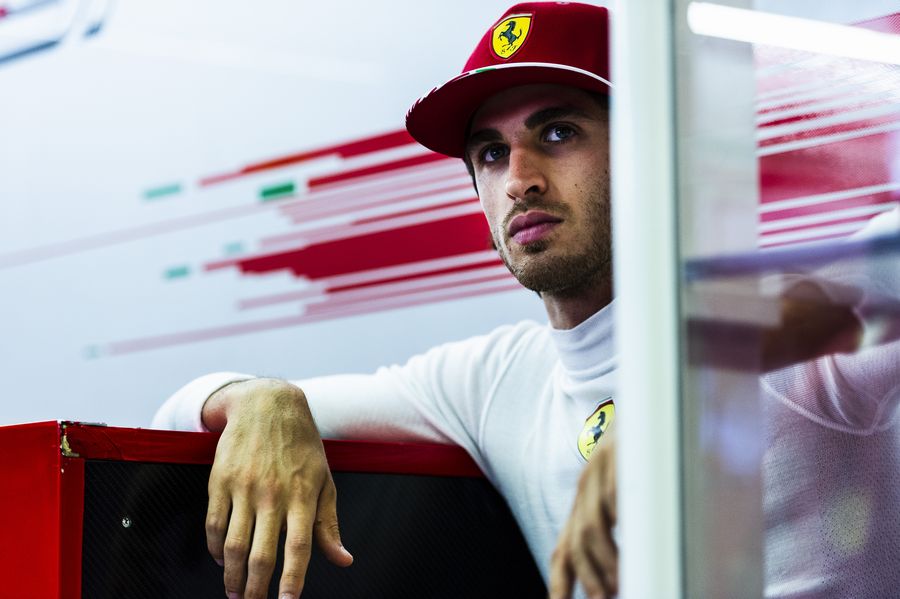 Antonio Giovinazzi sits in the back of Ferrari garage