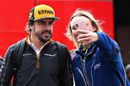 Fernando Alonso poses for a photo with fans in the Paddock