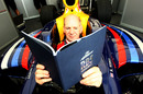 Adrian Newey studies the manual before driving the Red Bull Racing RB5 at the Goodwood Festival of Speed
