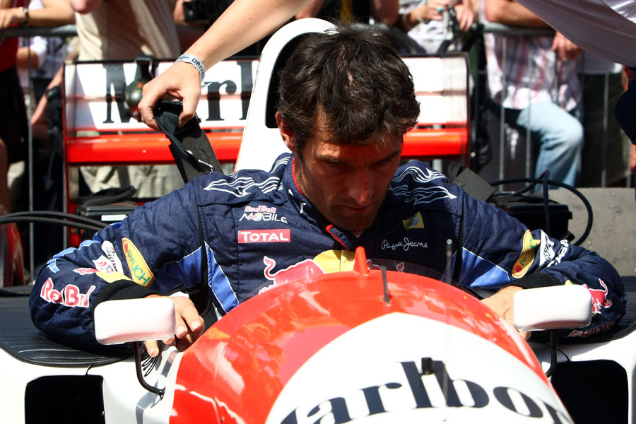 Mark Webber lowers himself into in the McLaren of Aryton Senna at Goodwood