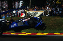 The Ligier of Jacques Laffite is carried away after a start line crash that ended his career 