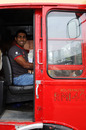 HRT driver Karun Chandhok at the wheel of a Routemaster bus at the Cosworth factory