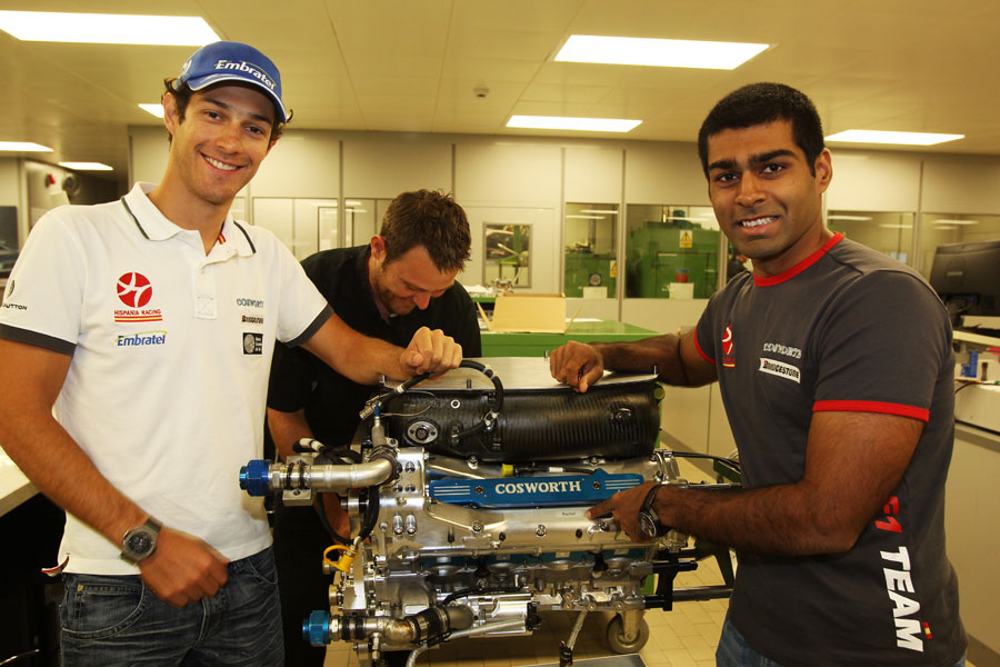 Karun Chandhok and Bruno Senna with an engine at the Cosworth factory