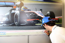 Bruno Senna signs a photo at the Cosworth factory