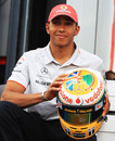Lewis Hamilton poses with his new helmet design for the British Grand Prix
