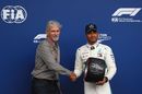 Lewis Hamilton receives the Pirelli Pole Position Award from Damon Hill
