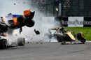 The car of Nico Hulkenberg is damaged as Fernando Alonso crashes