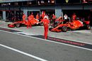 Sebastian Vettel and Kimi Raikkonen pulls out of the Ferrari garage