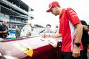 Sebastian Vettelsigns his car on the drivers parade