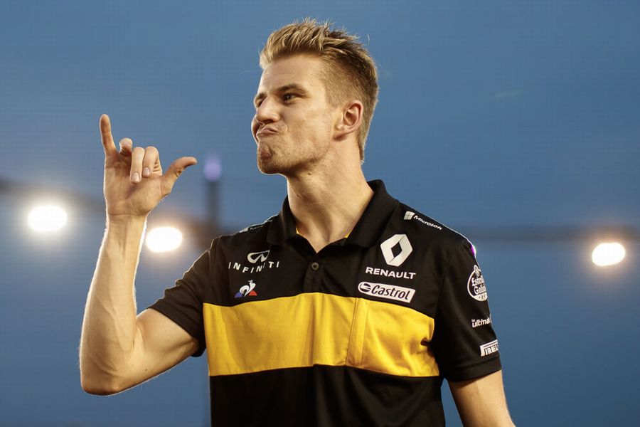 Nico Hulkenberg makes a drinking gesture on the drivers parade