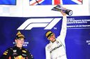 Race winner Lewis Hamilton celebrates on the podium with the trophy