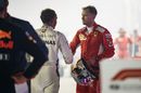 Race winner Lewis Hamilton shakes hands with Sebastian Vettel in parc ferme