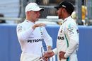 Pole sitter Valtteri Bottas talks with Lewis Hamilton in parc ferme