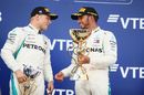 Race winner Lewis Hamilton and Valtteri Bottas celebrate on the podium