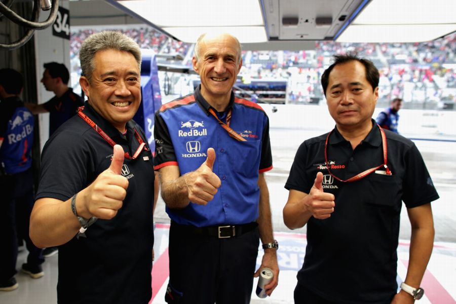 Franz Tost celebrates with Toyoharu Tanabe and Masashi Yamamoto in the garage