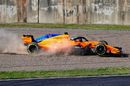 Fernando Alonso runs through the gravel trap