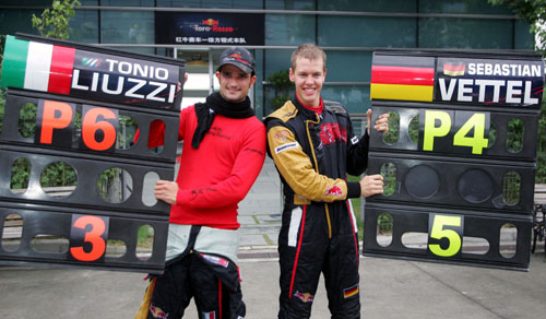 Tonio Liuzzi and Sebastian Vettel celebrate Toro Rosso's best ever race finish