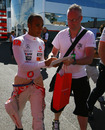 Lewis Hamilton signs an autograph before free practice