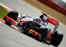 Lewis Hamilton brushes over the kerbs in his McLaren