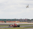 Felipe Massa races as a helicopter flies the great and the good into the circuit