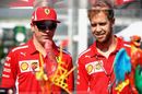 Kimi Raikkonen and Sebastian Vettel look at a paddock display