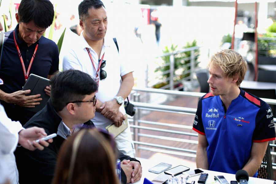 Brendon Hartley talks to the media in the Paddock