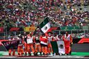 Course marshalls display a Mexican national flag