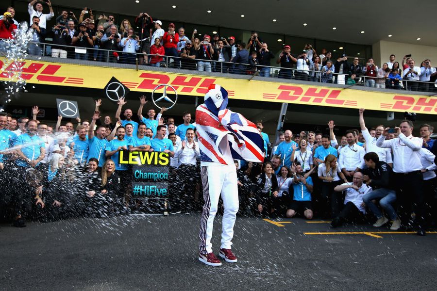 World Drivers Champion Lewis Hamilton celebrates with his team