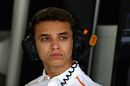 Lando Norris looks on from the garage