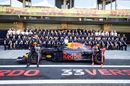 Daniel Ricciardo, Max Verstappen and the rest of the Red Bull Racing team pose for a photo in the Pitlane