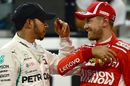Pole sitter Lewis Hamilton talks with Sebastian Vettel in parc ferme