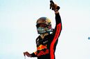 Daniel Ricciardo waves to the crowd from parc ferme
