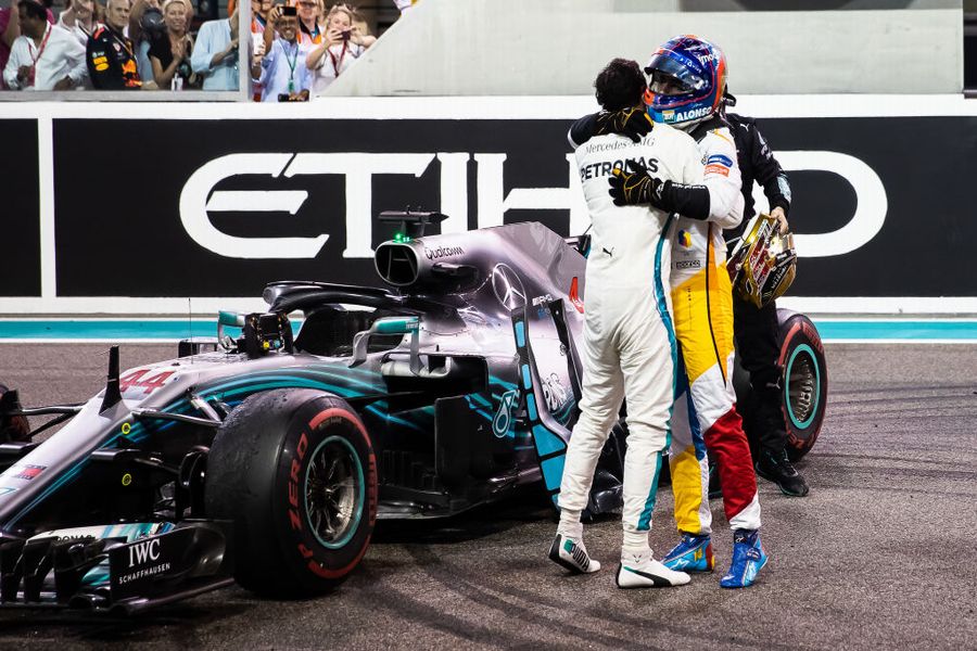 Race winner Lewis Hamilton celebrates with Fernando Alonso