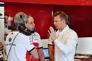 Kimi Raikkonen speaks with his engineers in Sauber garage