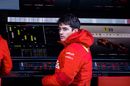 Charles Leclerc watches the session from the pit wall