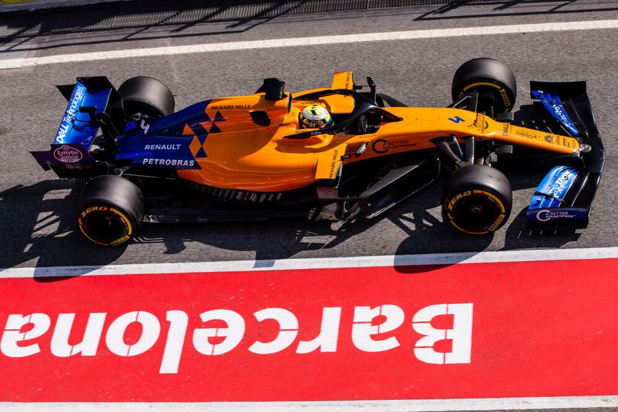 Lando Norris powers down the pit lane in the McLaren