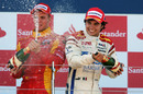 Sergio Perez celebrates his win alongside Dani Clos who finished third