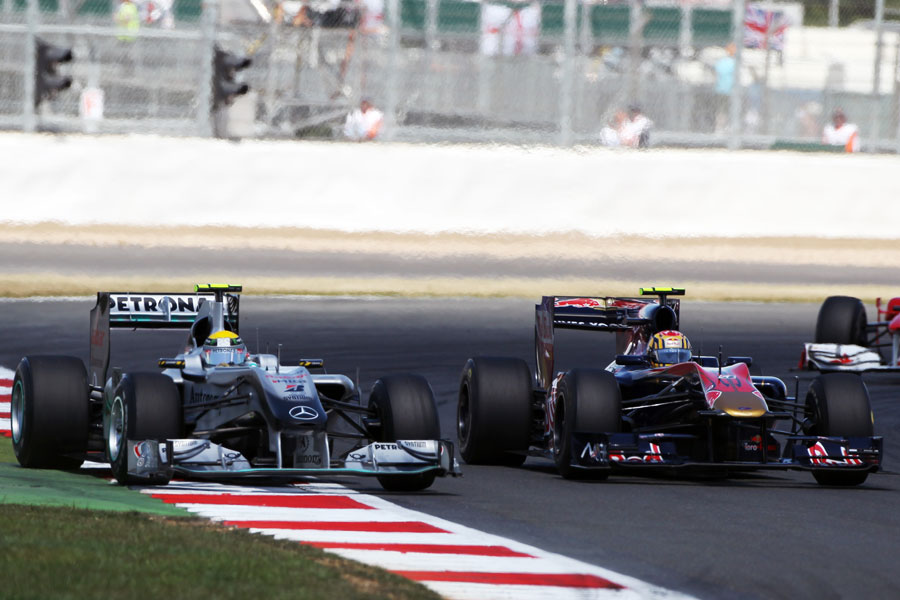 Nico Rosberg overtakes Jaime Alguersuari around the outside of Brooklands