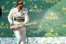 Lewis Hamilton celebrate on the podium with the champagne