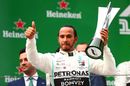 Race winner Lewis Hamilton celebrate on the podium with the trophy