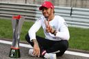 Race winner Lewis Hamilton poses for a photo with his trophy