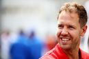Sebastian Vettel smiles in the Paddock