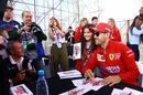 Sebastian Vettel poses for a photograph with fans