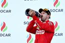 Sebastian Vettel celebrate on the podium with the champagne