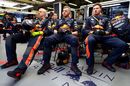 The Red Bull Racing team watch the action in the garage