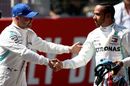 Pole sitter Valtteri Bottas shakes hands with Lewis Hamilton in parc ferme